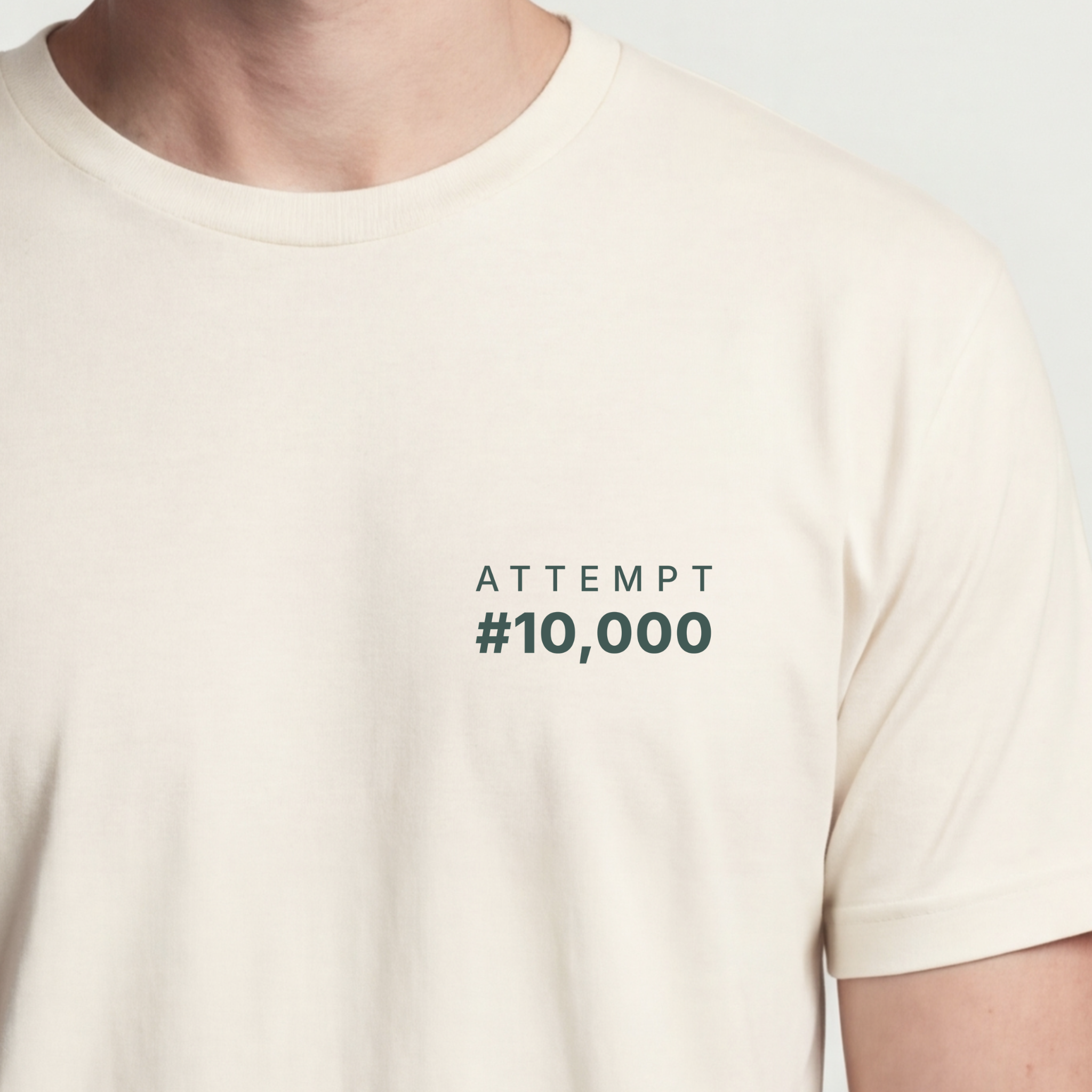 Founder Threads | Attempt #10,000 Technical Tee. Natural Bone minimalist design for developers. Hero crop view.