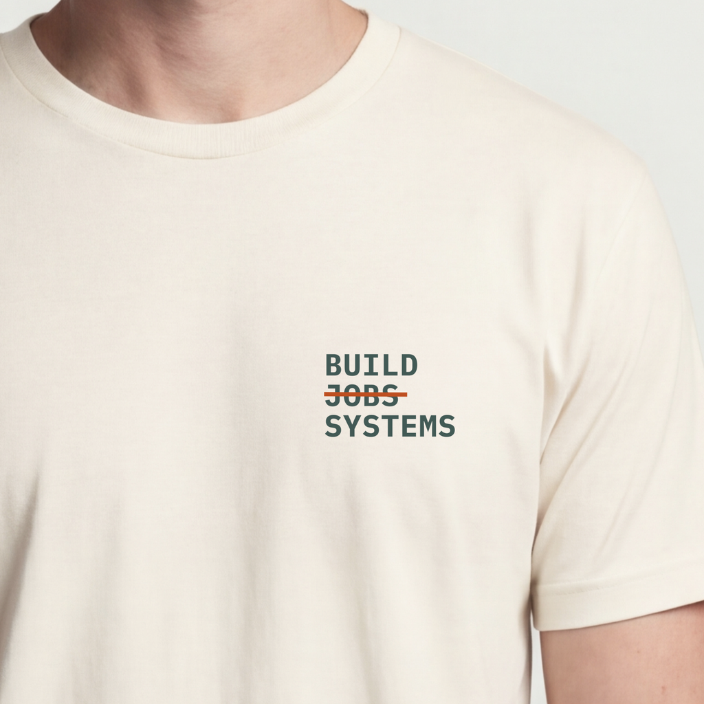 Founder Threads | Build Systems Not Jobs Tee - Design-Forward Builder Gear - Natural Bone - Hero Crop. Light-tone essential for the creative builder.