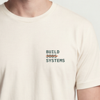 Founder Threads | Build Systems Not Jobs Tee - Design-Forward Builder Gear - Natural Bone - Hero Crop. Light-tone essential for the creative builder.