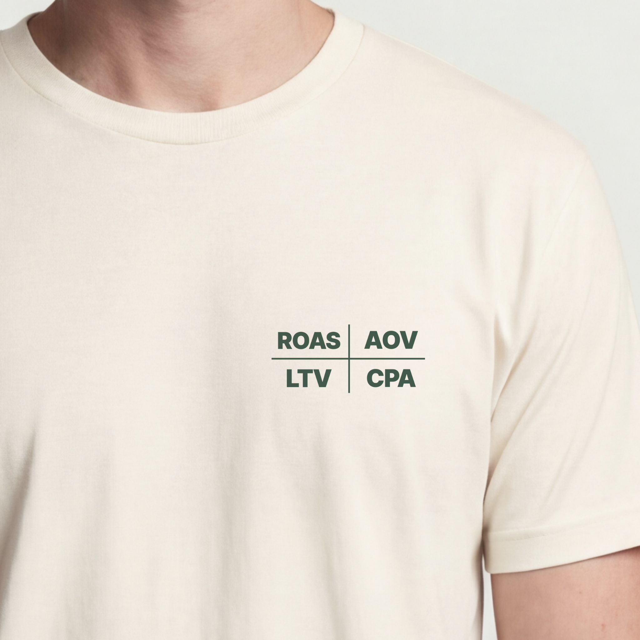 Founder Threads | ROAS* AOV LTV CPA Technical Tee - Natural Bone - Hero Crop. Minimalist typography for software engineers and founders.