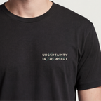Founder Threads | Uncertainty Is The Asset Tee - System Black - Hero Crop. Gift for contrarian founders and risk-takers.